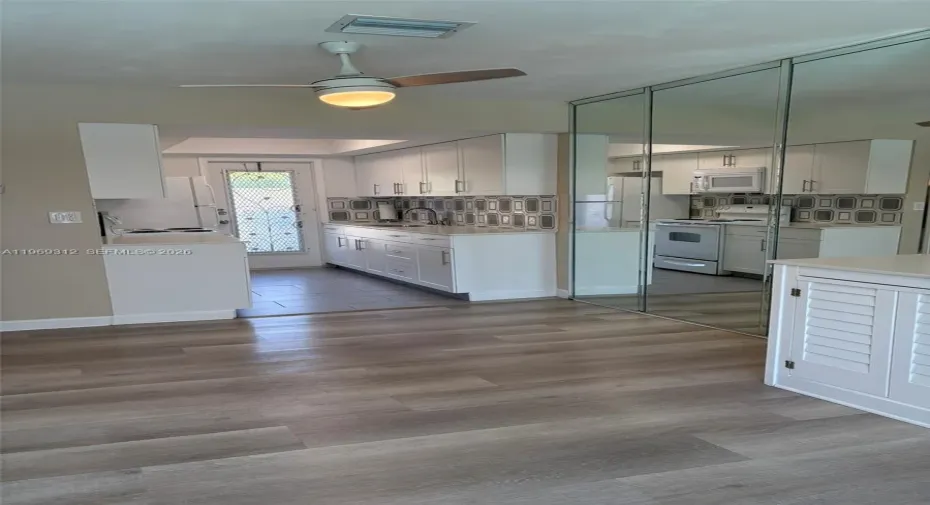 Remodeled kitchen with back door leading to assigned parking spot