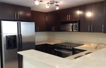 UPGRADED KITCHEN WITH GRANITE COUNTERTOPS, STAINLESS STEEL APPLIANCES, WOOD CABINETS & MARBLE FLOORS