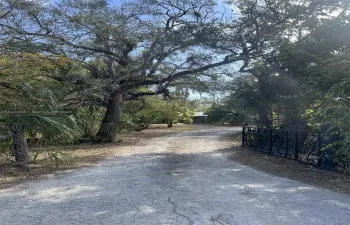 INVITING AND ENCHANTING ENTRY WAY WITH CUSTOM BUILT IRON GATE