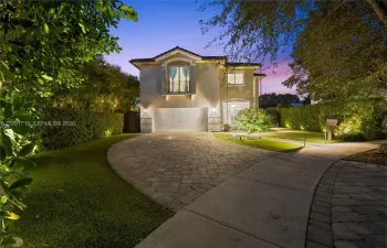 A bright and welcoming foyer features high-volume ceilings and polished marble-look flooring with a custom decorative medallion inlay.