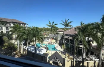 View of outside and the pool as one waits for the elevator.