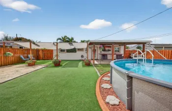 Freshly stained fence. Artificial turf