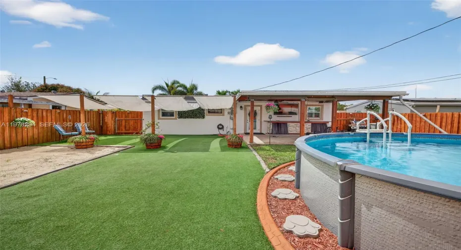 Freshly stained fence. Artificial turf