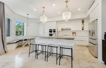 Modern kitchen natural light flooded open concept and high ceilings with quartz counter tops in private gated Aventura Lakes