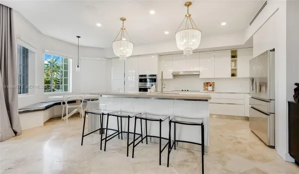 Modern kitchen natural light flooded open concept and high ceilings with quartz counter tops in private gated Aventura Lakes