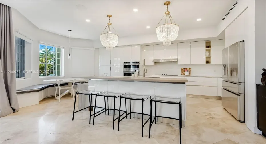 Modern kitchen natural light flooded open concept and high ceilings with quartz counter tops in private gated Aventura Lakes