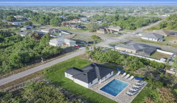 Aerial perspective of suburban area featuring a pool