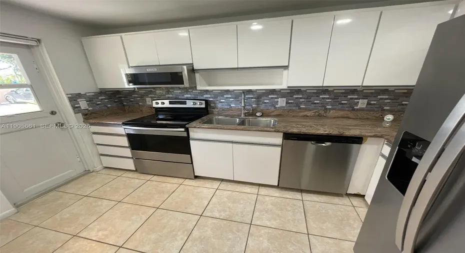 Kitchen with New Stainless Steel Appliances and Recessed Ceiling Lights