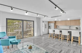 Stylish sunny living room open to kitchen