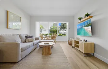 Open concept dining and living room area, connects to the enclosed patio.