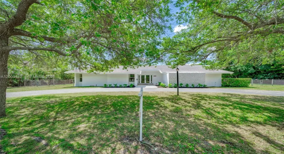 Lush Lanscaping 1/2 acre of land with a charming Home with pool