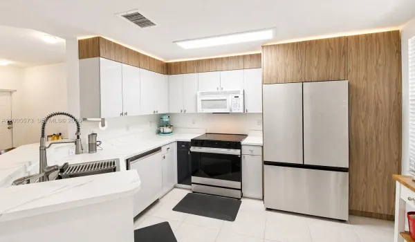 Sharp renovated kitchen complete with cabinetry ambient up lighting