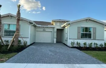 Front of home with large driveway and attached garage