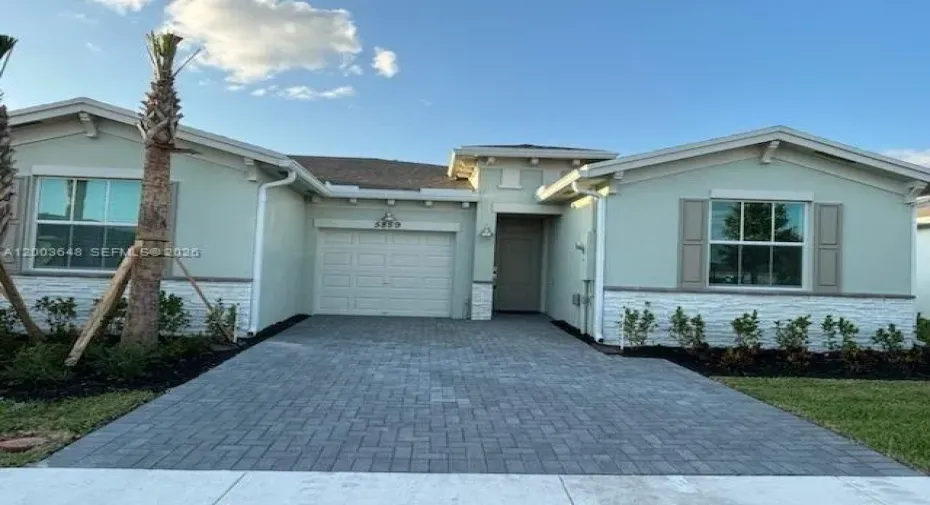 Front of home with large driveway and attached garage
