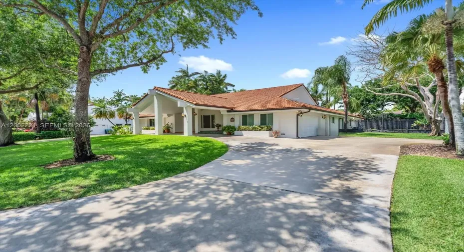 Concrete circular driveway with a 2car side entry garage