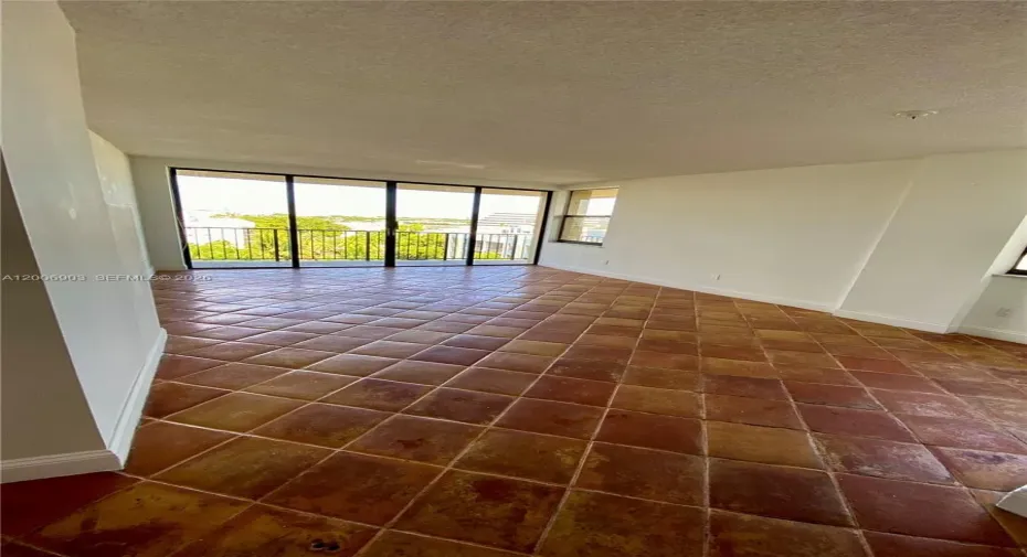 Bright and airy living room with abundant natural light, featuring a private balcony and two additional side windows—an exclusive benefit of this corner unit.