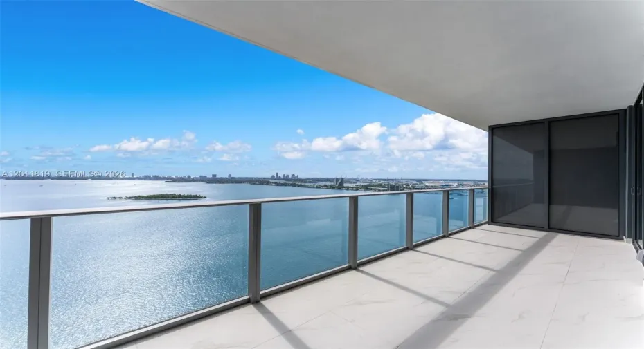 Breathtaking panoramic sunrise views of Biscayne Bay and the Atlantic Ocean from the expansive private terrace of Aria Reserve #2504 in Edgewater, Miami.