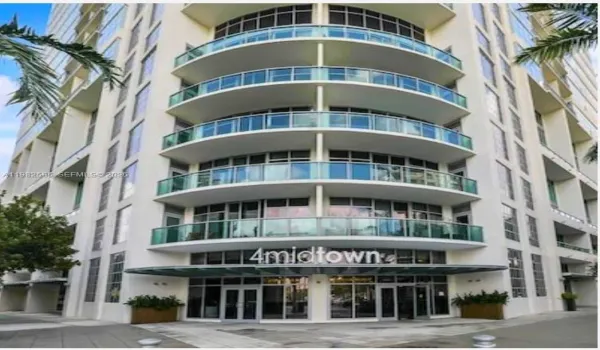 Contemporary building fa&ccedil;ade featuring rounded glass balconies and street level lobby entrance.