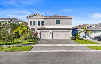 A modern two-story home with fresh landscaping and a wide driveway.