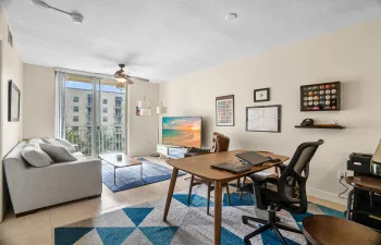 OPEN LIVING AREA WITH POOL VIEW FROM BALCONY