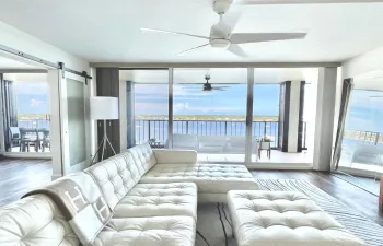 Step Inside and be instantly surrounded by shimmering water views- an open, light-filled entry that draws your eye to the water from every angle.