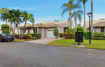 Charming villa with lush tropical landscaping and a welcoming approach. The paver driveway, one car garage, and private entry create great curb appeal while reflecting the relaxed South Florida lifestyle in this beautifully maintained community.