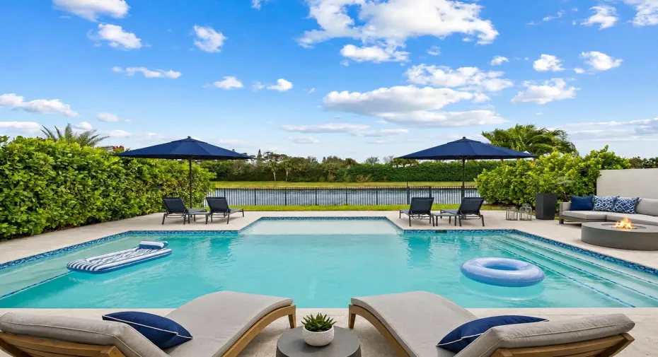 The newly installed pool, extended patio and lake view and lounge chairs are an actual photo. Other furniture and floats are virtually added.