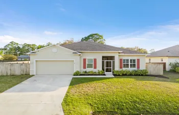 Attractive front elevation with screened entry and charming exterior accents.