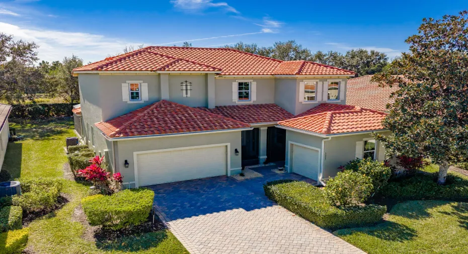 Welcome home!! Mediterranean / spanish house with stucco siding, a garage, decorative driveway, a tile roof, and a front lawn