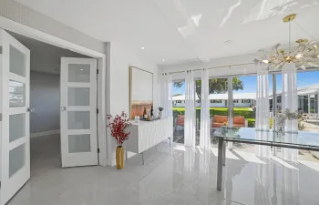 Spacious and bright dining area with view of patio and garden. Large Hurricane Impact sliding doors provide safety