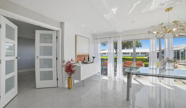 Spacious and bright dining area with view of patio and garden. Large Hurricane Impact sliding doors provide safety