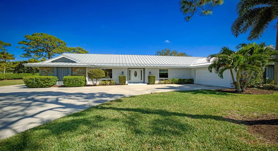 PBG home on over 1/2 acre of land with golf course views and interior canal.