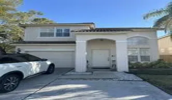 Front door with garage and an additional driveway to park 2 cars