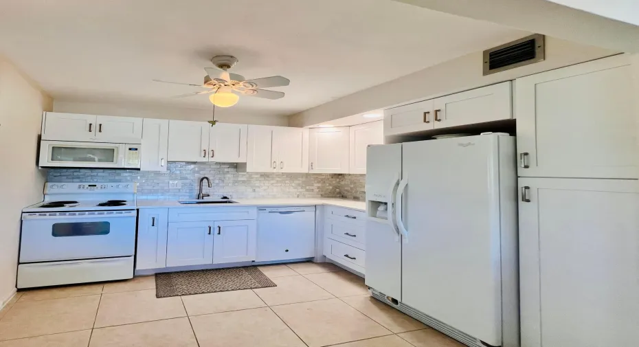 WOW! Updated 2/2 Corner Penthouse With Water Views in the Luxury Wellington Section of Century Village!