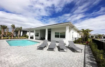 Pool deck and fenced in backyard.