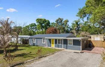 Ranch-style home featuring asphalt driveway and covered porch