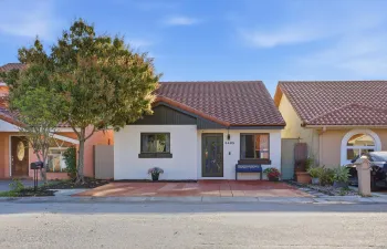 Enhancing the home’s curb appeal is a gorgeous, mature mango tree in the front yard, offering shade, beauty, and a true South Florida lifestyle touch.