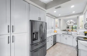 Kitchen w expansive counter & cabinets