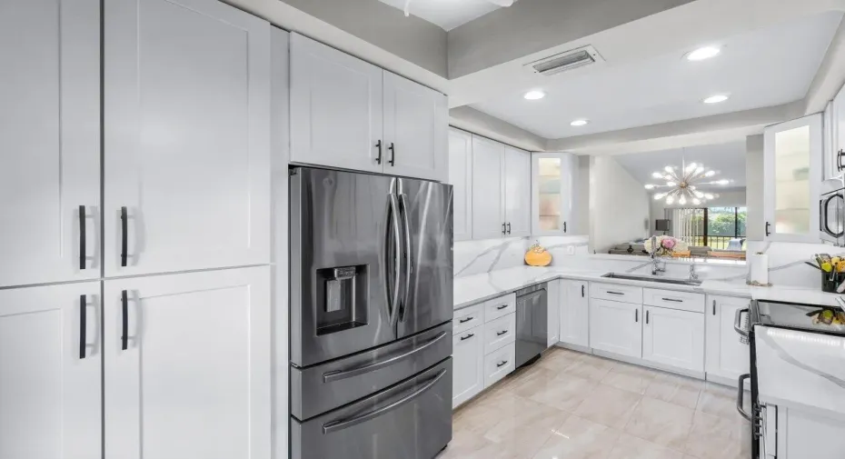 Kitchen w expansive counter & cabinets