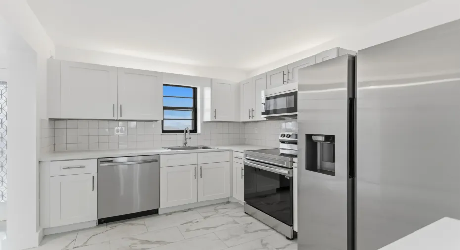 Beautiful Remodeled Kitchen w/shaker style cabinets, stainless steel appliances, luxury vinyl flooring