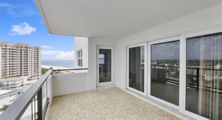 View past the impact sliders from large balcony toward beach
