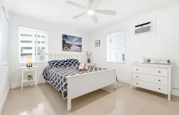 Bedroom with walk in closet, and a/c and flat screen tv