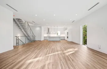 Bright, open, kitchen and living space with Miele and Samsung appliances.