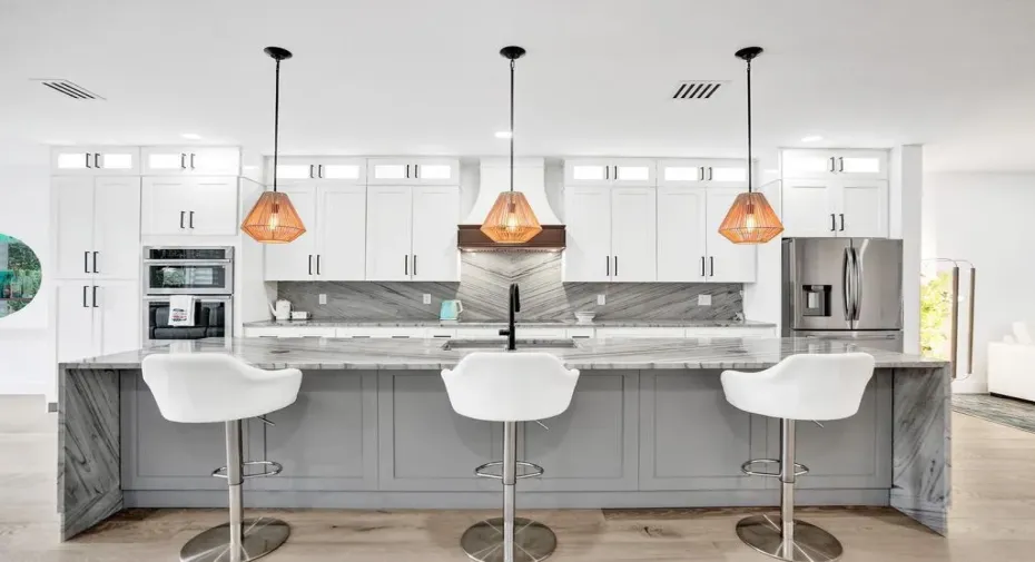 This meticulous newly renovated home boasts the bright open concept with floor to wall hurricane impact windows and high ceilings.