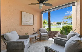 PICTURESQUE BACK PATIO WITH LAKE VIEW, WALKING PATH, & STEPS FROM THE RESORT STYLE SWIMING POOL