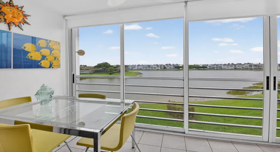 Enclosed balcony has sliding glass doors that opens to screens to enjoy Florida's beautiful weather