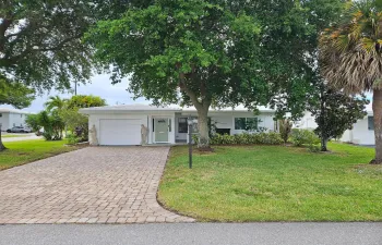 Corner lot with large, covered, front porch and double wide, 4 car paver driveway (2023)