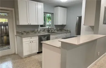 NEWER kitchen cabinets, brand new quartz counters, brand new stainless steel appliances.