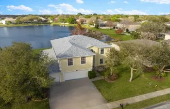 Lakefront Corner Home with Loft, Den and 2 screened patios! 4 bedrooms 2.5 bathrooms, 3 car garage, huge backyard with fruit trees and recent updates includes 2025 roof, 2022 AC,, 2023 water heater. Lower HOA in a gated community – perfect blend of comfort and style! Call to schedule your private showing today!