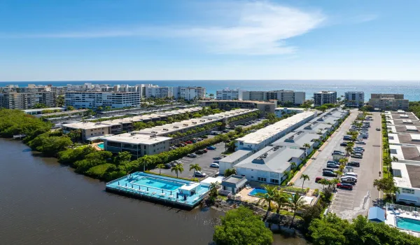 Spectacular view of Tropicana Garden's community pool overlooking South Palm Beach Intracoastal with private direct beach access across the street.